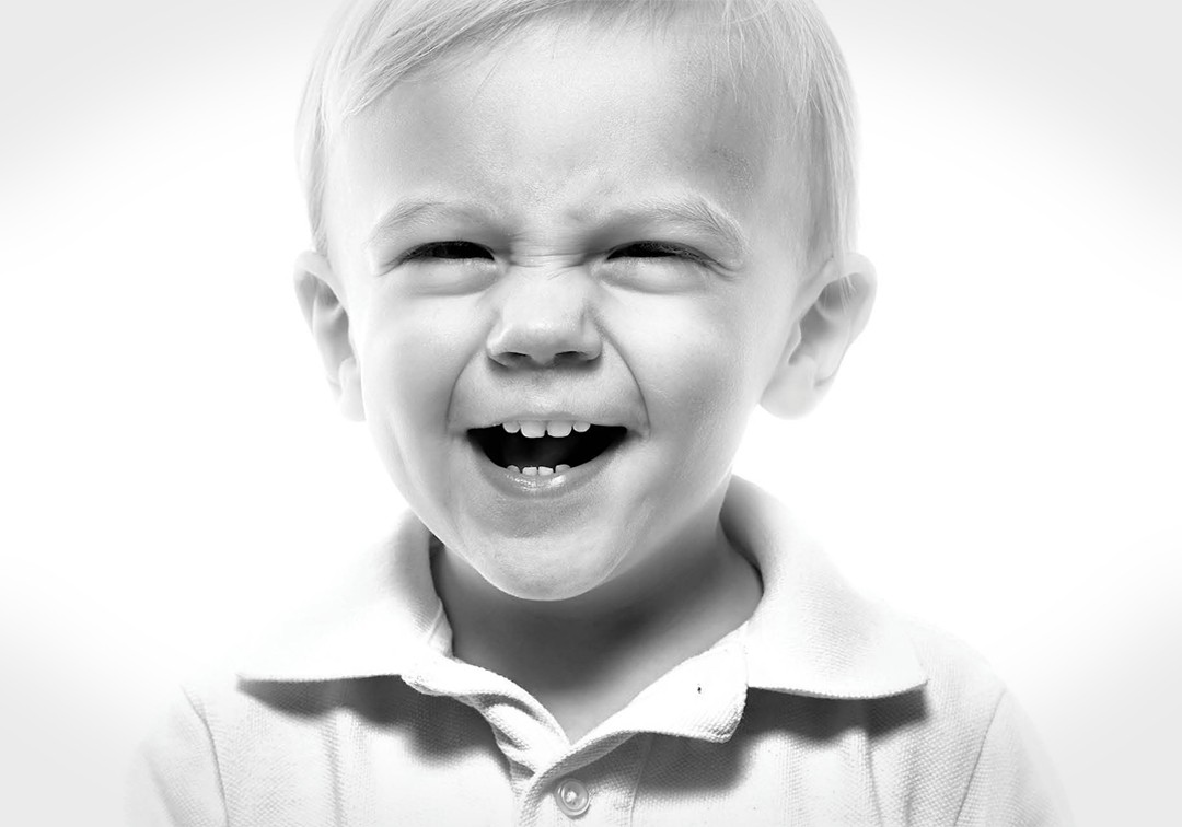 Happy and Smily Kid in a black in white.